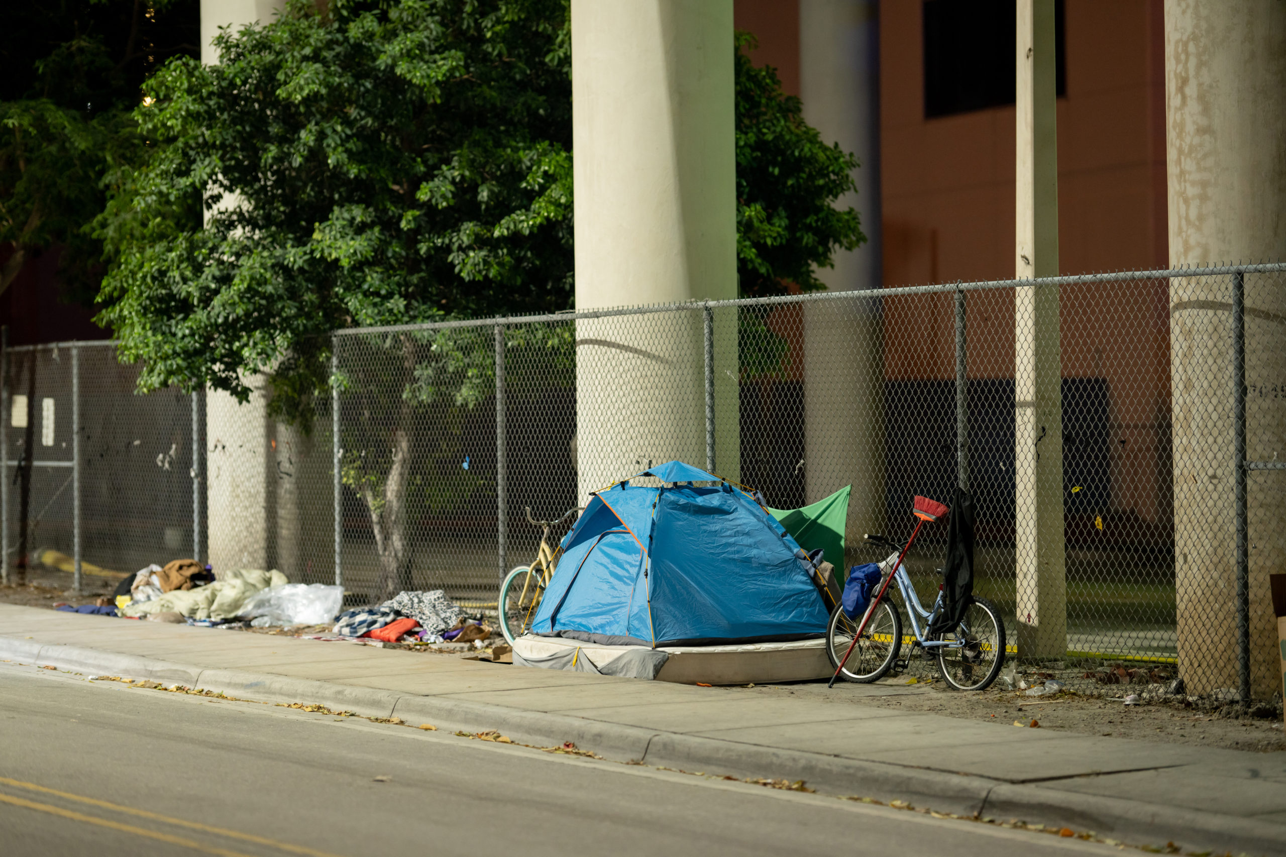 Homeless camp in tents on city sidewalk