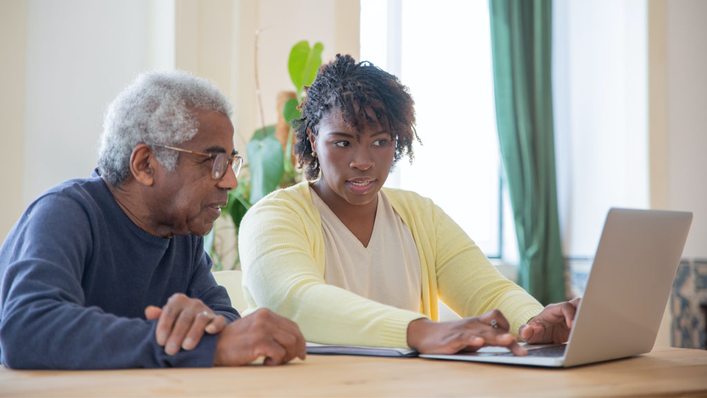 Photo of man and woman working at computer
