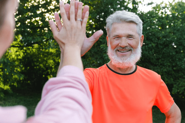 Photo of man and woman giving each other a high five