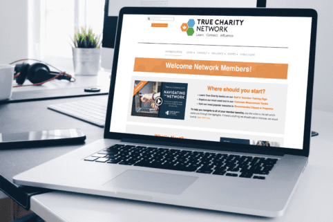 Photo of laptop showing the True Charity Network members' portal
