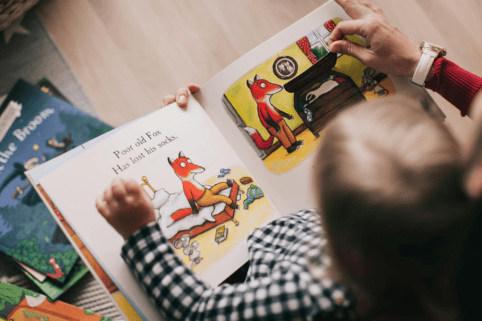Closeup photo of child reading picture book