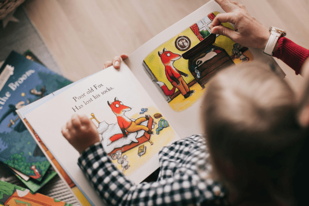 Closeup photo of child reading picture book