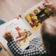 Closeup photo of child reading picture book