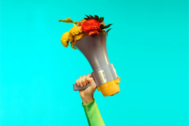 Photo of megaphone with flowers coming out of it