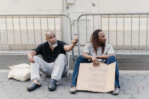 Photo of homeless and poor men on street asking for money
