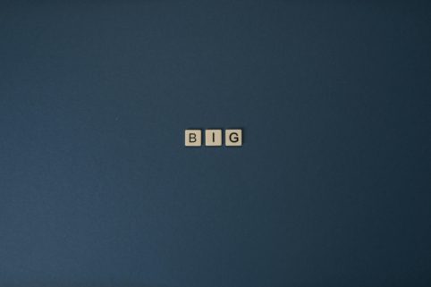 Photo of Scrabble letter tiles spelling out 'BIG'