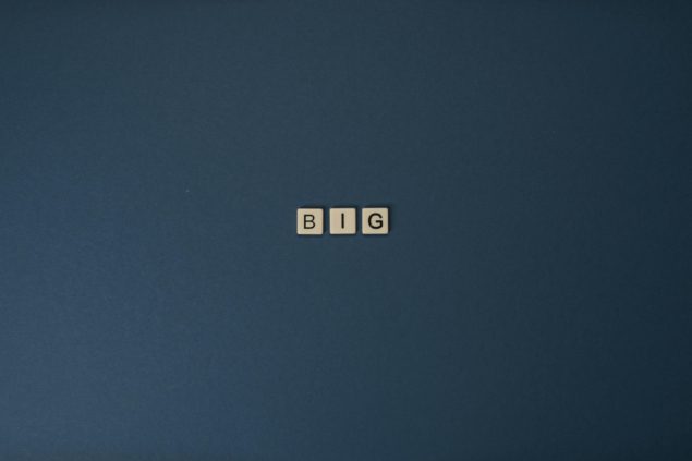 Photo of Scrabble letter tiles spelling out 'BIG'