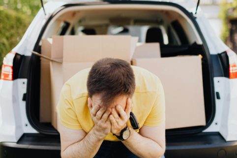 Photo of man clutching his head in his hands