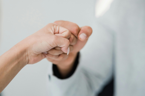 Photo of fistbump between people
