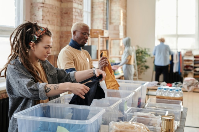 Photo of charity volunteers sorting clothing and other goods