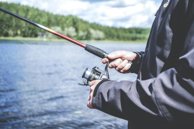 Closeup of man fishing on lake
