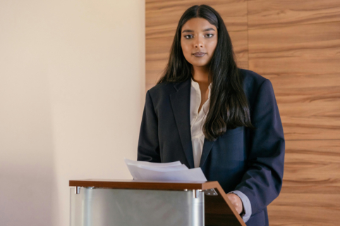 Photo of lady presenting talk at conference
