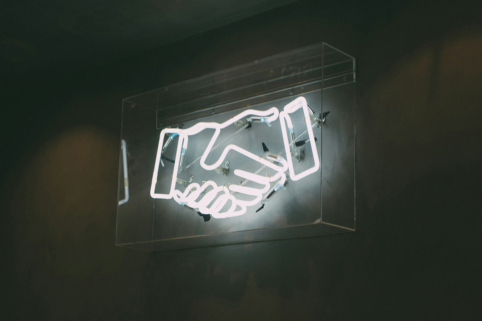 Photo of neon sign of handshake