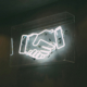 Photo of neon sign of handshake