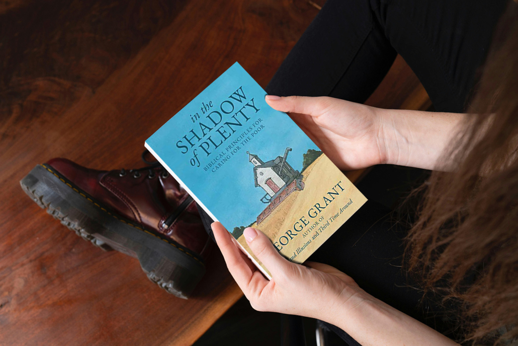 Photo of woman holding book, In the Shadow of Plenty