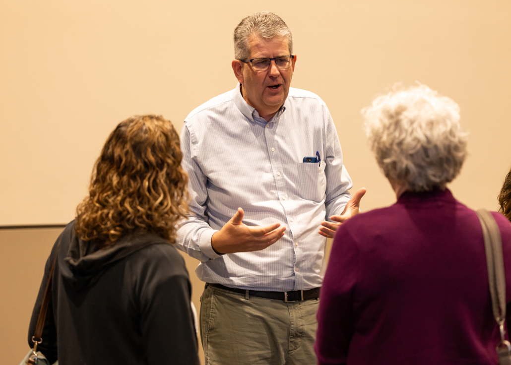 Photo of people talking with Brian Fikkert (author of When Helping Hurts) at the True Charity Summit