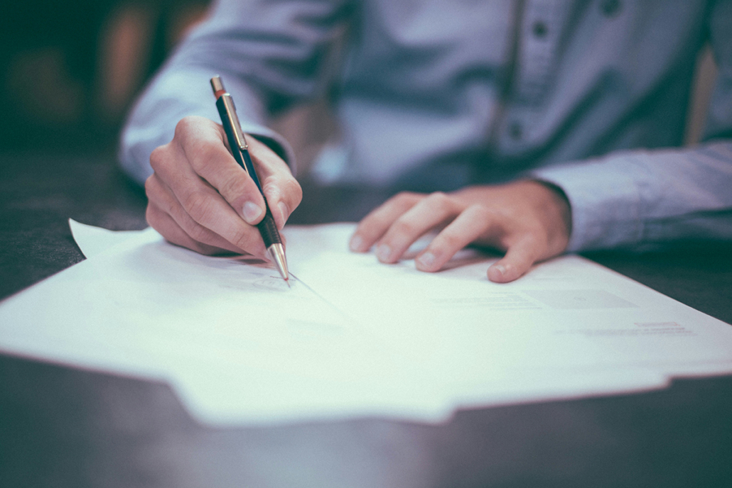 Photo of lawyer writing on documents